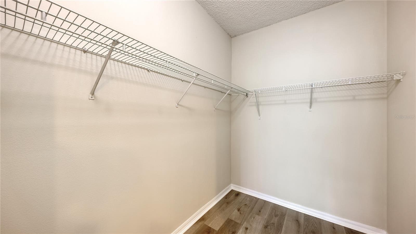 Spacious walk-in closet in the primary bedroom - 5551 BENTGRASS DR #11-117, SARASOTA