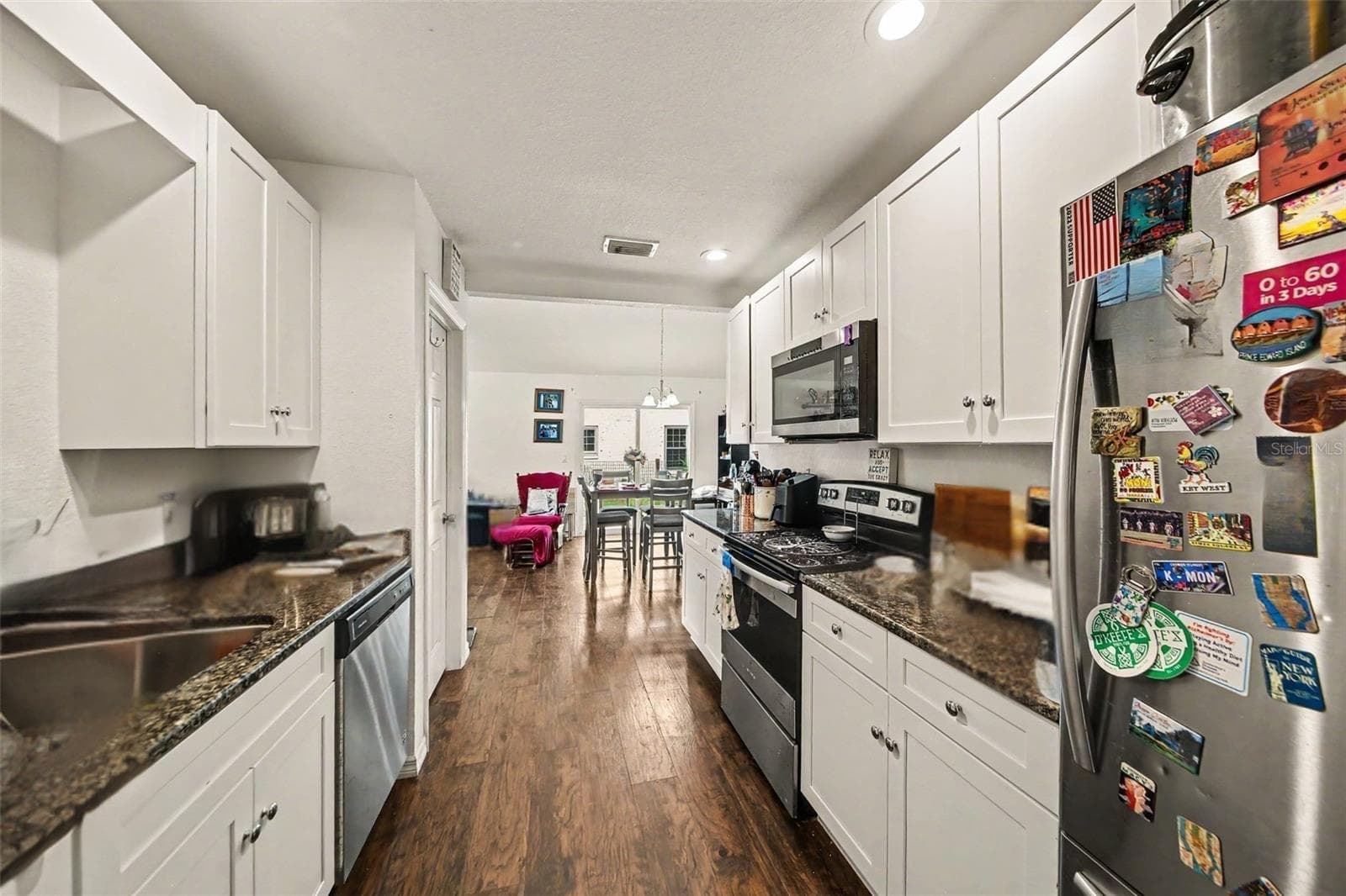 Smart galley way kitchen design with counter space. Appliances installed 2021. - 17050 SE 60TH ST, OCKLAWAHA
