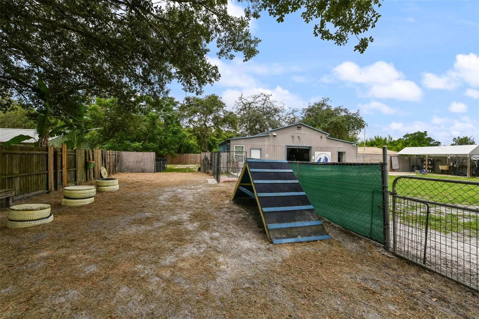 Large utility space that could be used for many purposes. Without the dog equipment here, you could also extend the driveway back this far, too! - 2036 LAKE VIEW AVE, CHULUOTA