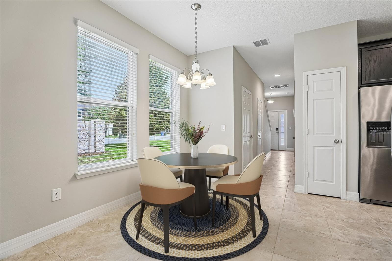 The end-unit location is a standout feature, offering EXTRA WINDOWS, a large SIDE YARD, and abundant NATURAL LIGHT throughout. Virtually Staged. - 198 MITCHELL CREEK WAY, OVIEDO