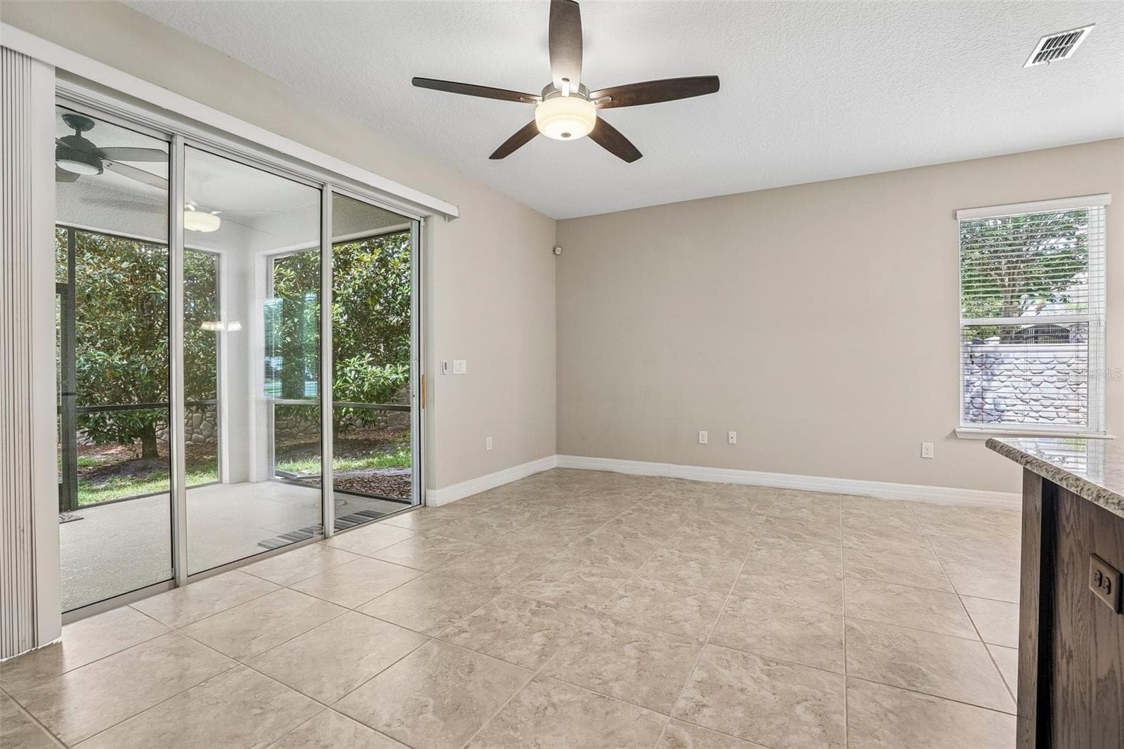 Triple sliding glass doors open up to the screened lanai. - 198 MITCHELL CREEK WAY, OVIEDO