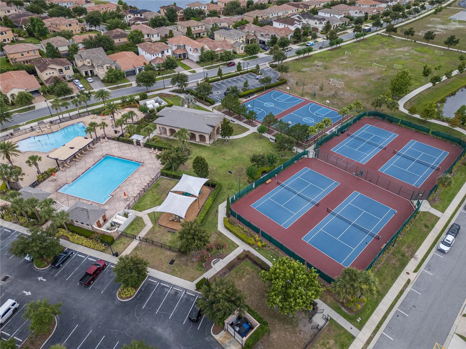 Recreational amenities: community pools, playground, pavilion, basketball courts, and tennis courts - 10751 BELFRY CIR, ORLANDO
