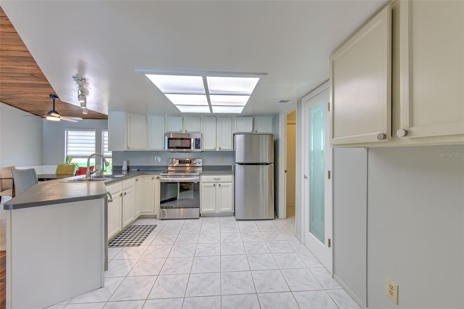 Kitchen open to living room and dining room - 2459 SHOREWOOD LN, LAND O LAKES