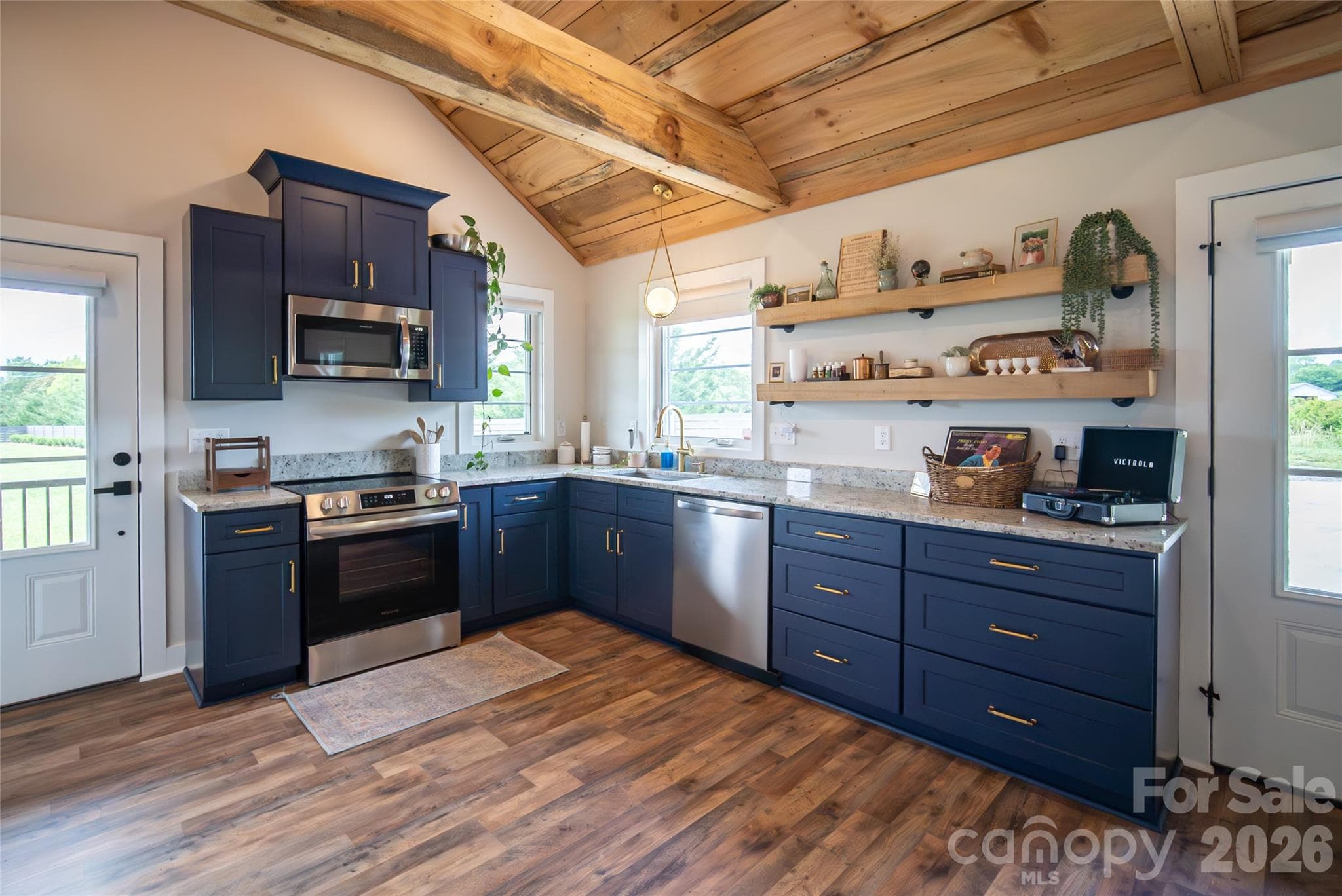 Guest cabin living area features warm finishes and an open-concept design. - 23 Benton Farms Lane, Horse Shoe