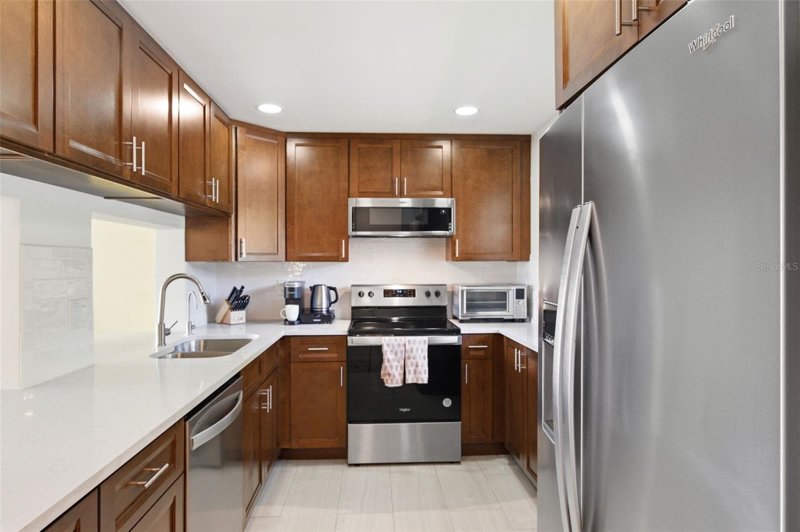 Fully updated Kitchen! Newer tile floors, recessed lighting, cabinets, granite counter tops, stainless steel appliances, and a reverse osmosis system under the kitchen sink. - 19029 US HIGHWAY 19 N #7-12, CLEARWATER