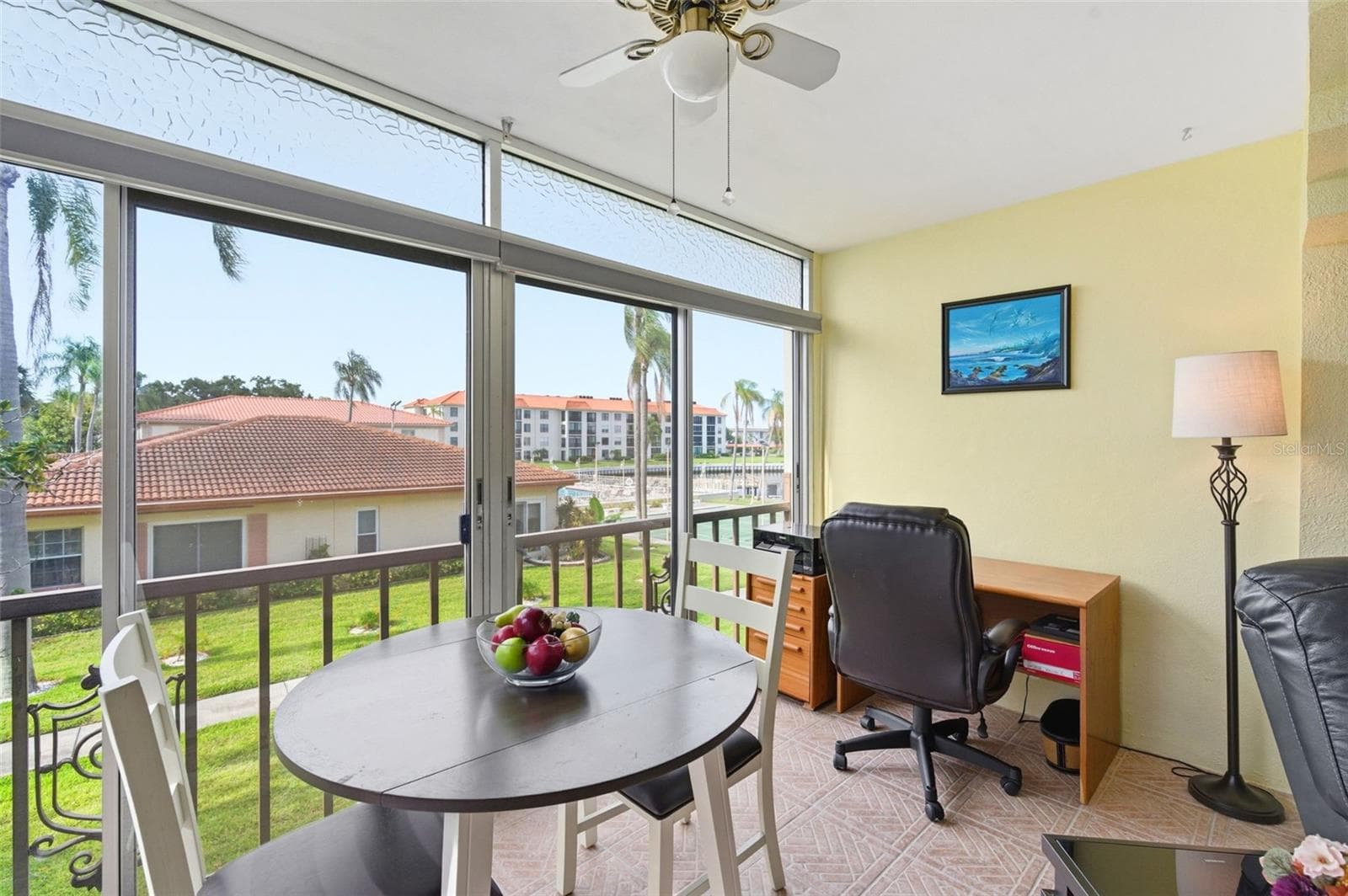Florida Room off of Living Room with views of the water, pool, and community amenities. - 19029 US HIGHWAY 19 N #7-12, CLEARWATER