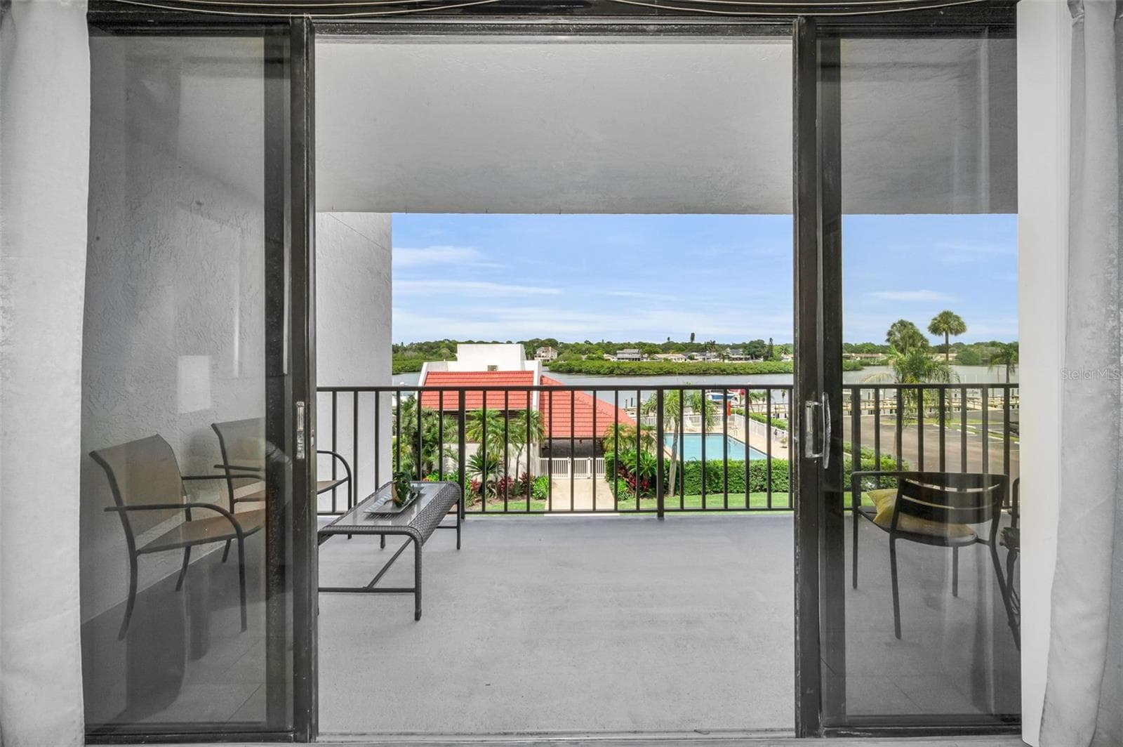 Step out from the Living area onto your waterfront balcony - 19111 VISTA BAY DR #304, INDIAN SHORES