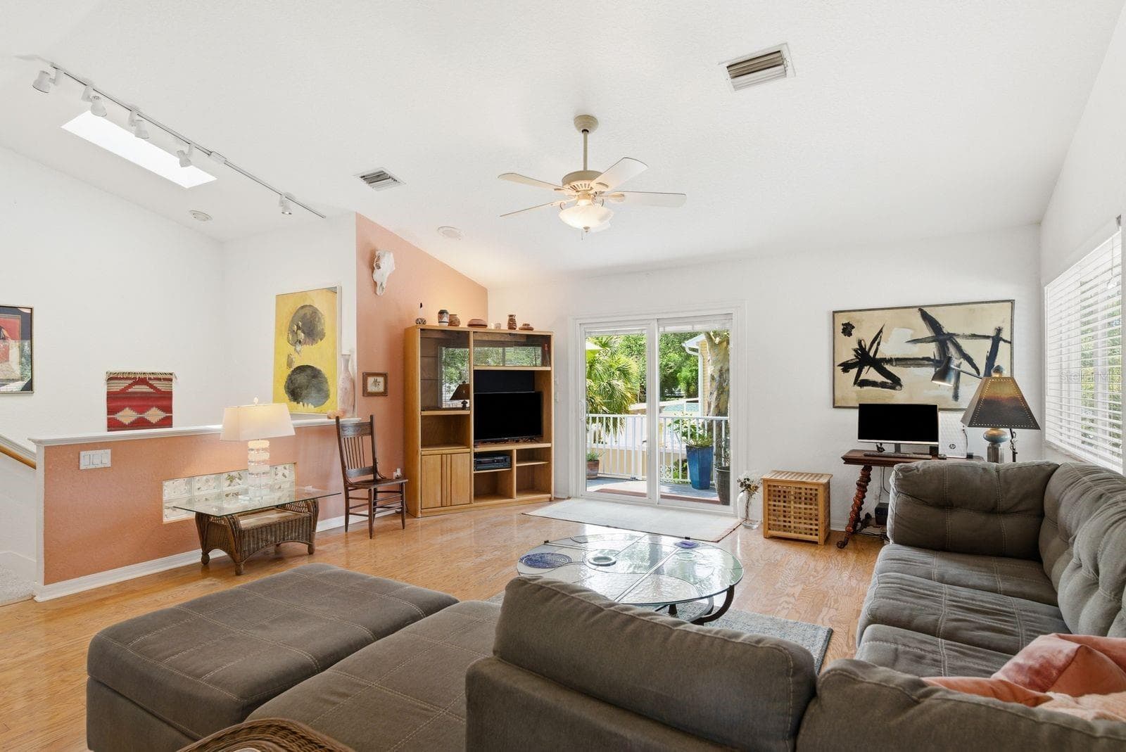 Living room with skylight over stairs and sliders to trex deck. - 755 SAN CHRISTOPHER DR, DUNEDIN