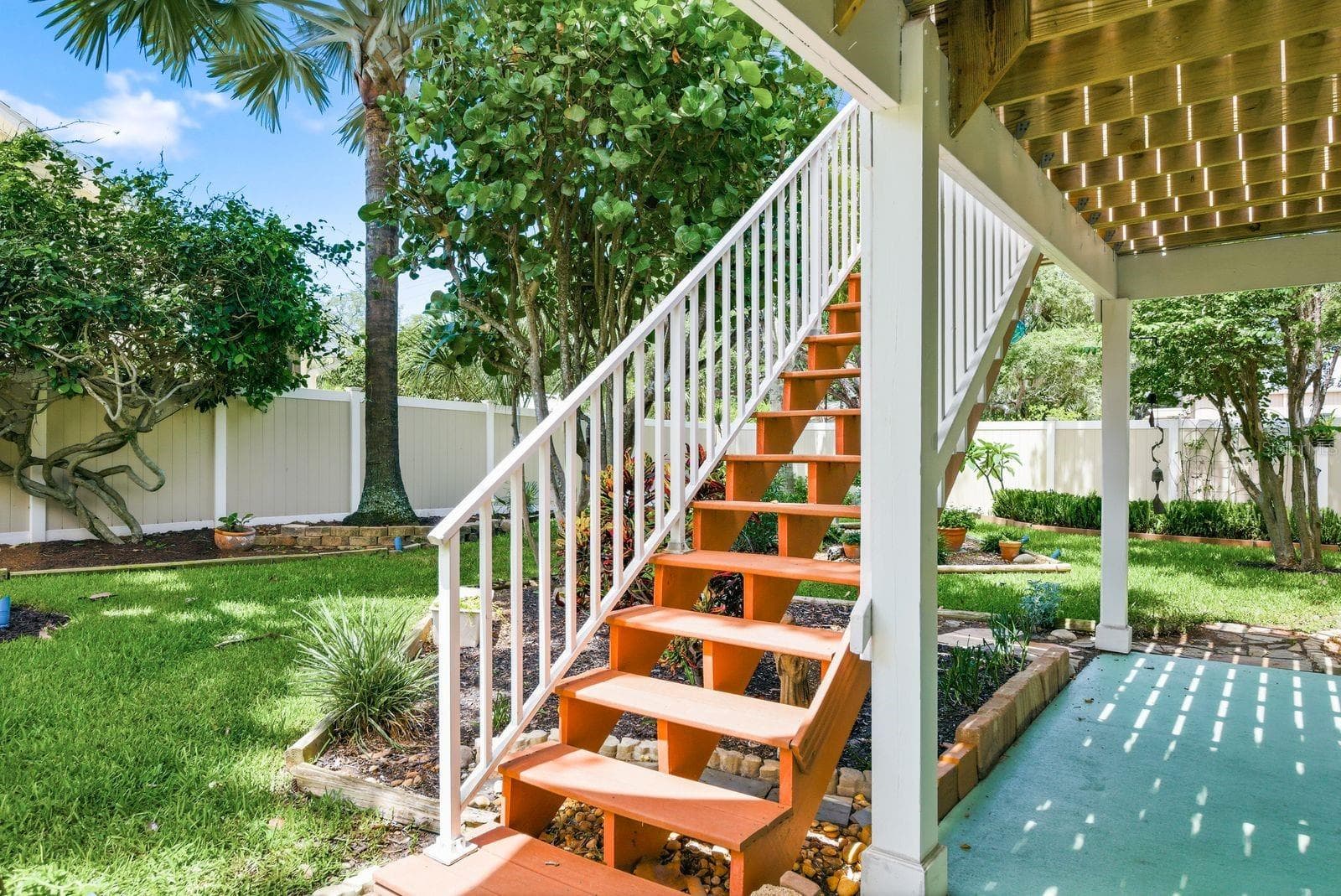 Newly rebuilt trex stairs from upstairs deck to backyard/downstairs patio. - 755 SAN CHRISTOPHER DR, DUNEDIN