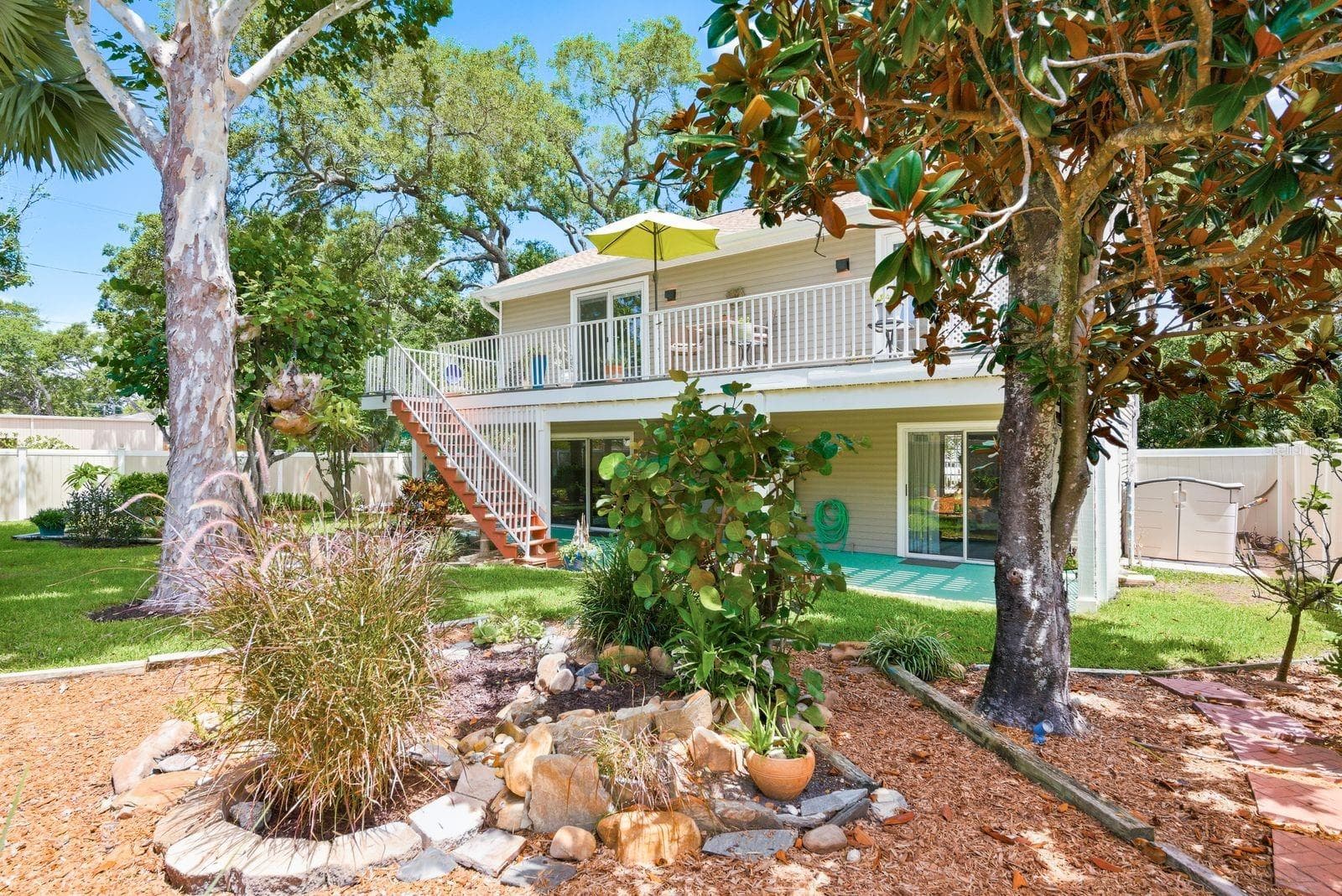 Garden with sycamore, florida wysteria, red maple, Palm tree, sea grape, hibiscus, frangipani & magnolia tree. - 755 SAN CHRISTOPHER DR, DUNEDIN