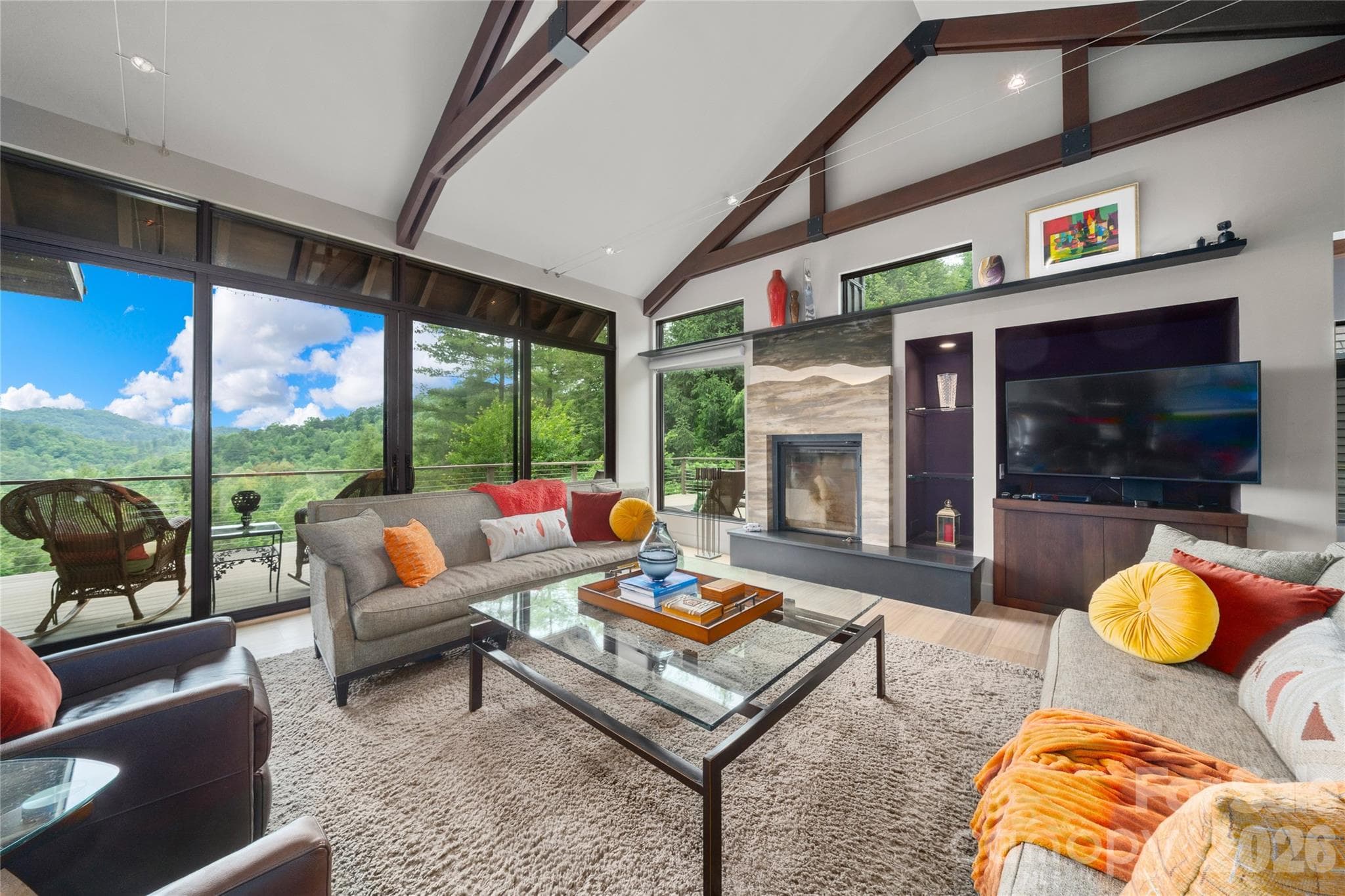Custom designed Renaissance fireplace with a retractable screen captures the mountain ridgeline. - Hendersonville