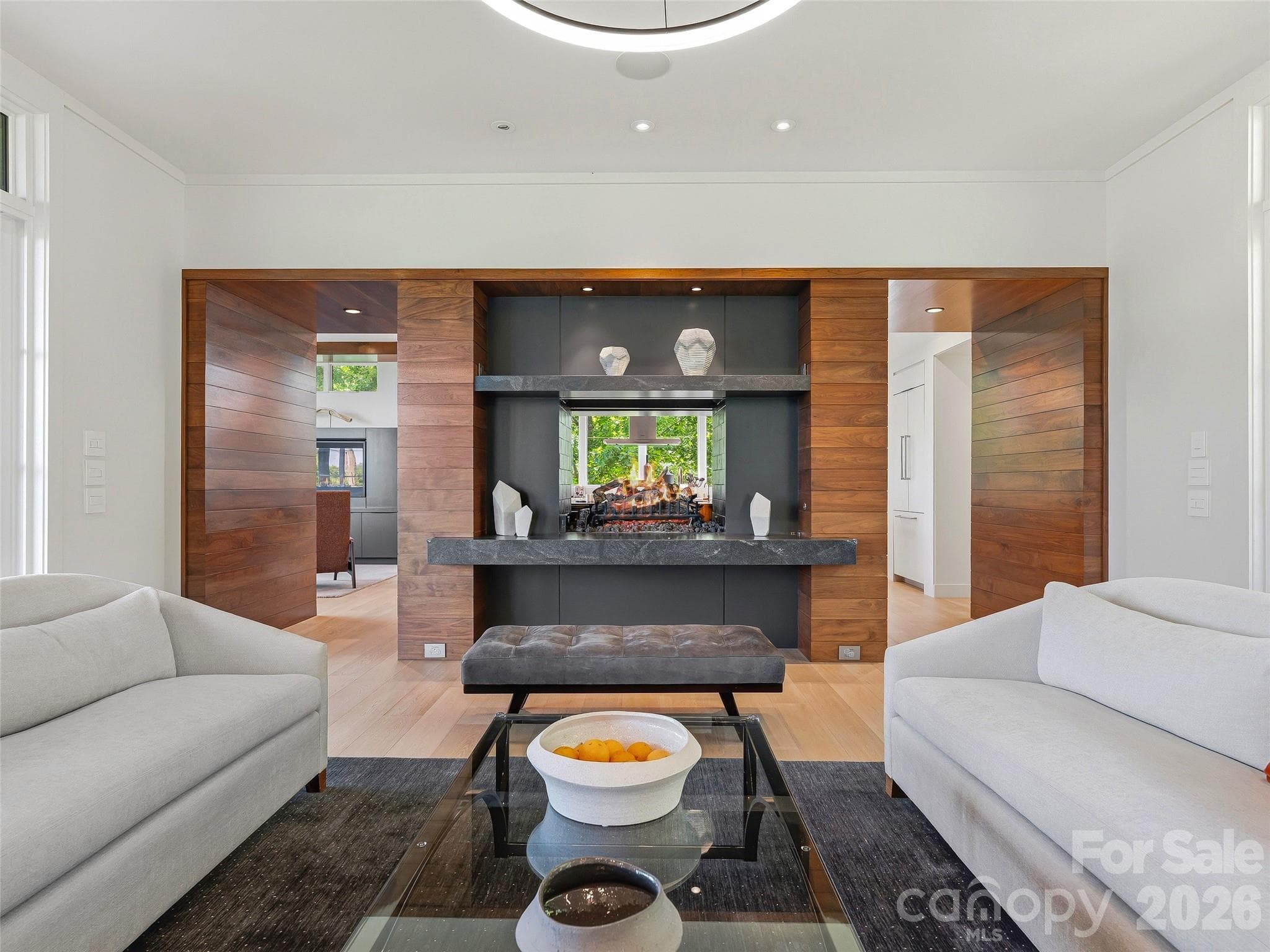 The great room flows effortlessly into the kitchen, anchored by a dramatic see-through fireplace - 1121 Timberbluff Way, Arden