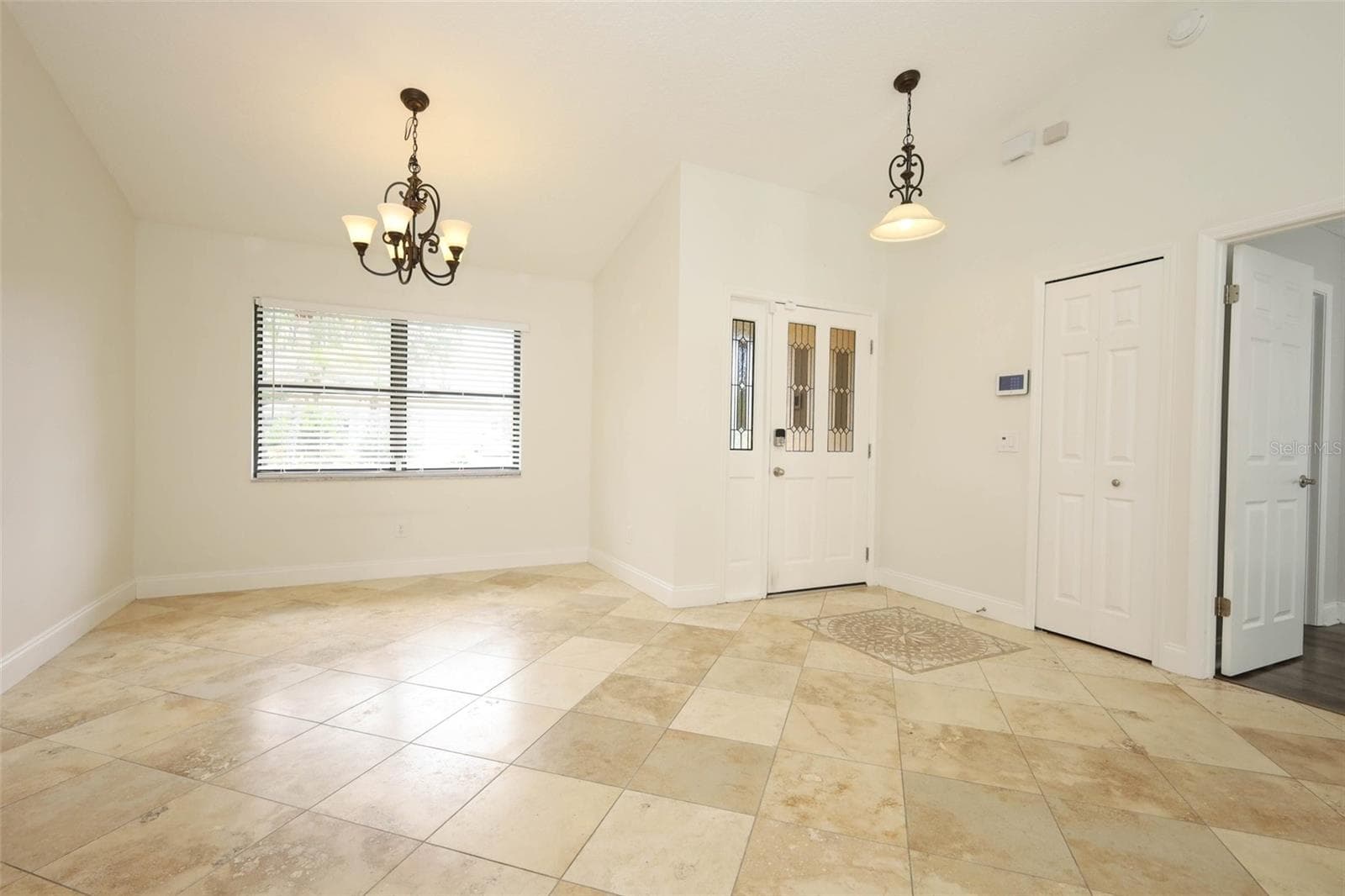 Foyer/dining room with Travertine tile flooring. - 9110 PALM TREE DR, WINDERMERE