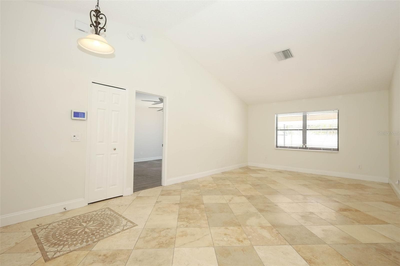 Formal living room with Travertine tile flooring. - 9110 PALM TREE DR, WINDERMERE