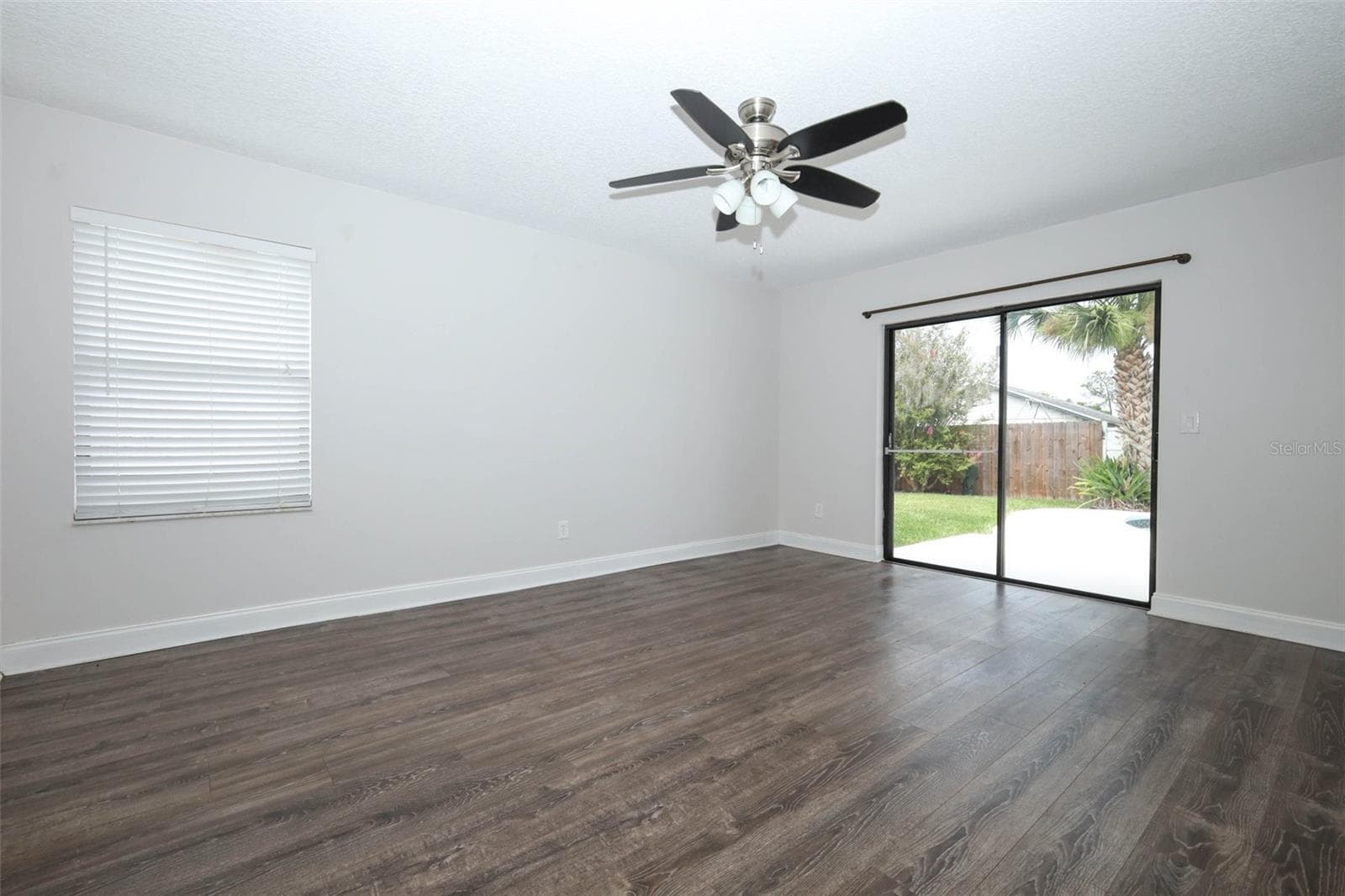 Primary bedroom with engineered hardwood flooring. - 9110 PALM TREE DR, WINDERMERE