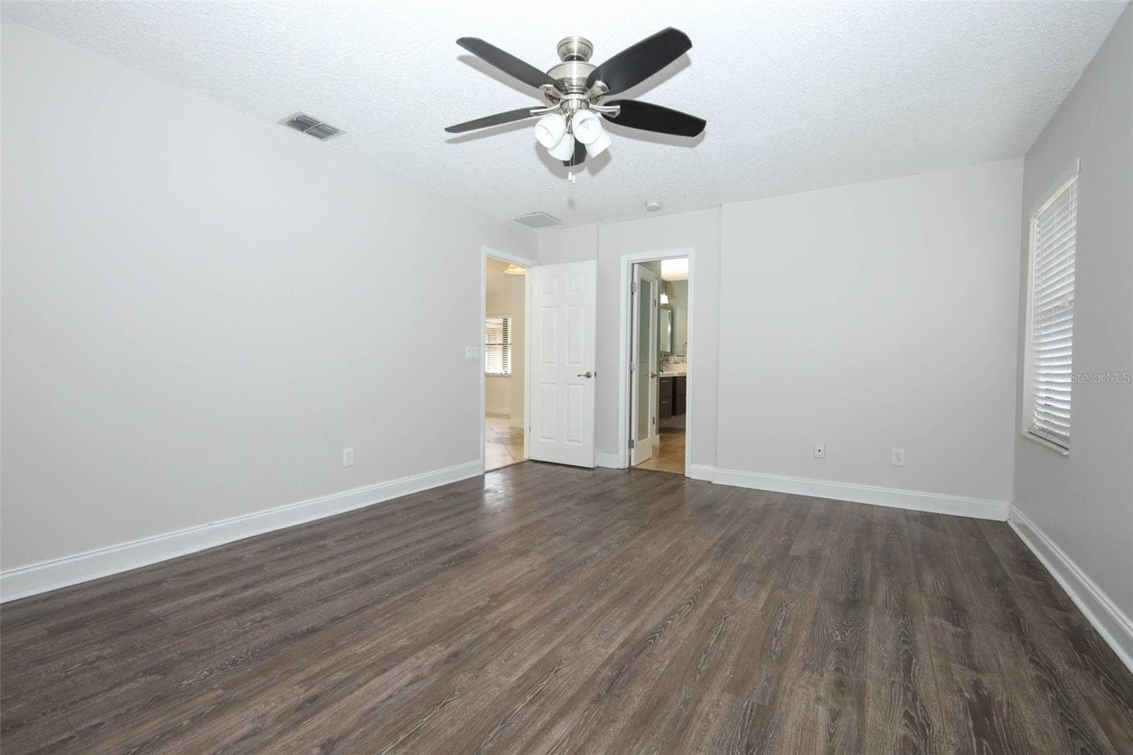 Primary bedroom with engineered hardwood flooring. - 9110 PALM TREE DR, WINDERMERE