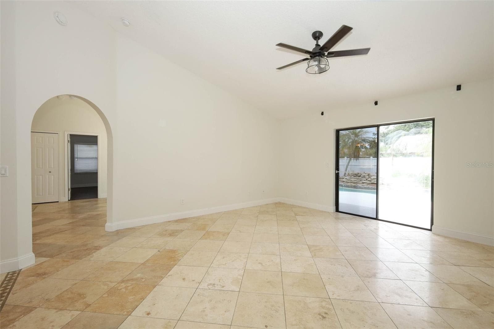 Family room with Travertine tile flooring. - 9110 PALM TREE DR, WINDERMERE