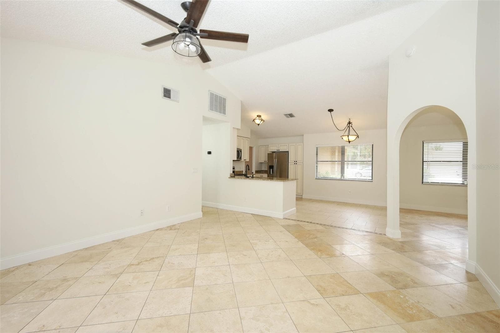 Family room with Travertine tile flooring. - 9110 PALM TREE DR, WINDERMERE