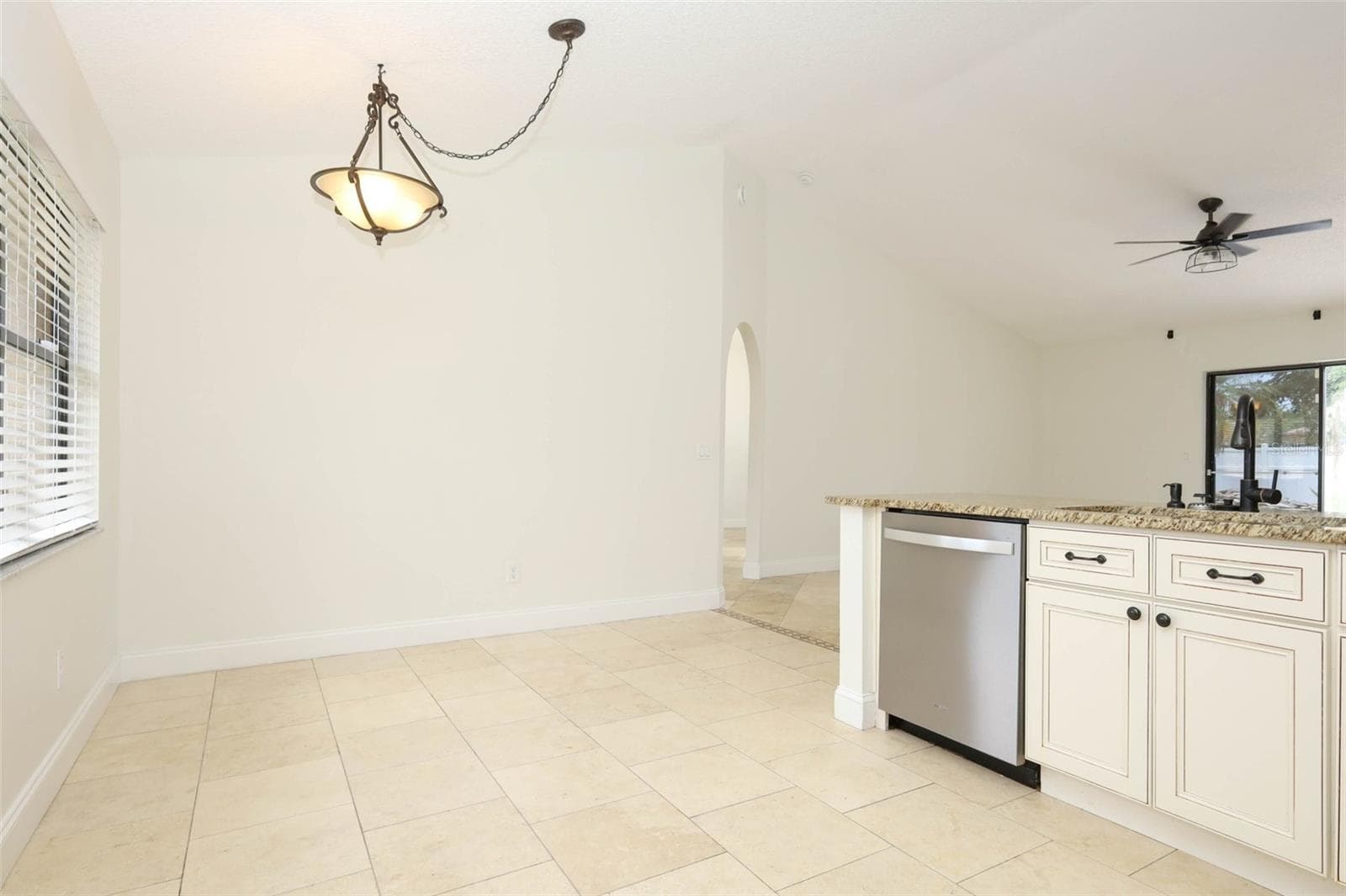 Eat-in space in kitchen with travertine tile flooring, granite countertops and stainless steel appliances. - 9110 PALM TREE DR, WINDERMERE