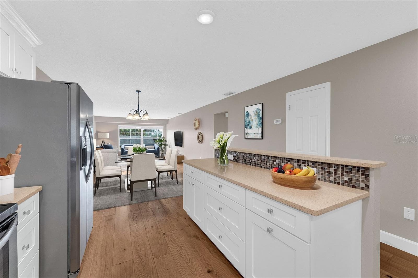 Updated Kitchen with Large Island. Open to Dining and Living Room.  Virtually Staged - 110 N TREMAIN ST #209, MOUNT DORA