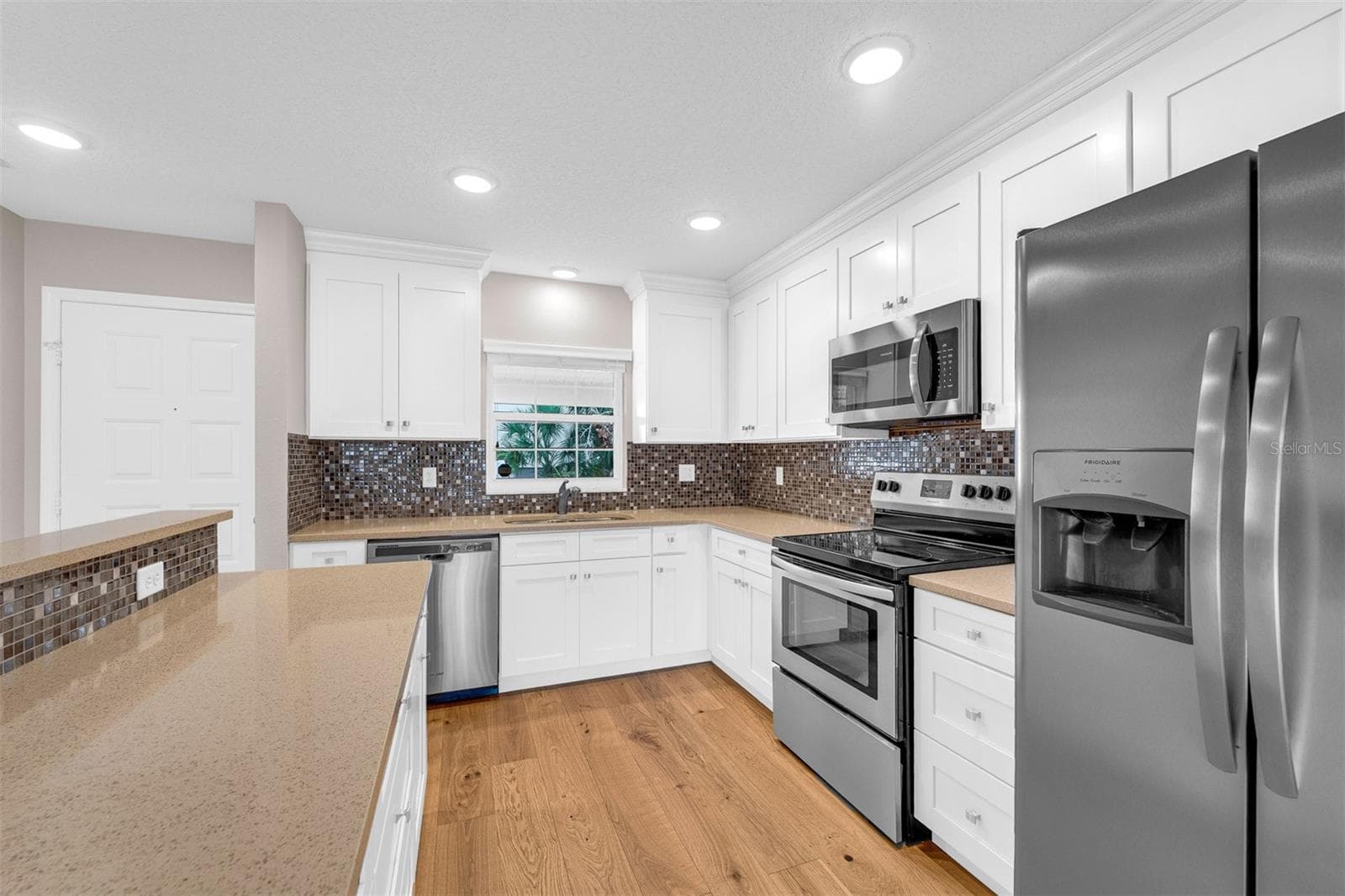 Window above kitchen sink allowing natural light to flow in - 110 N TREMAIN ST #209, MOUNT DORA