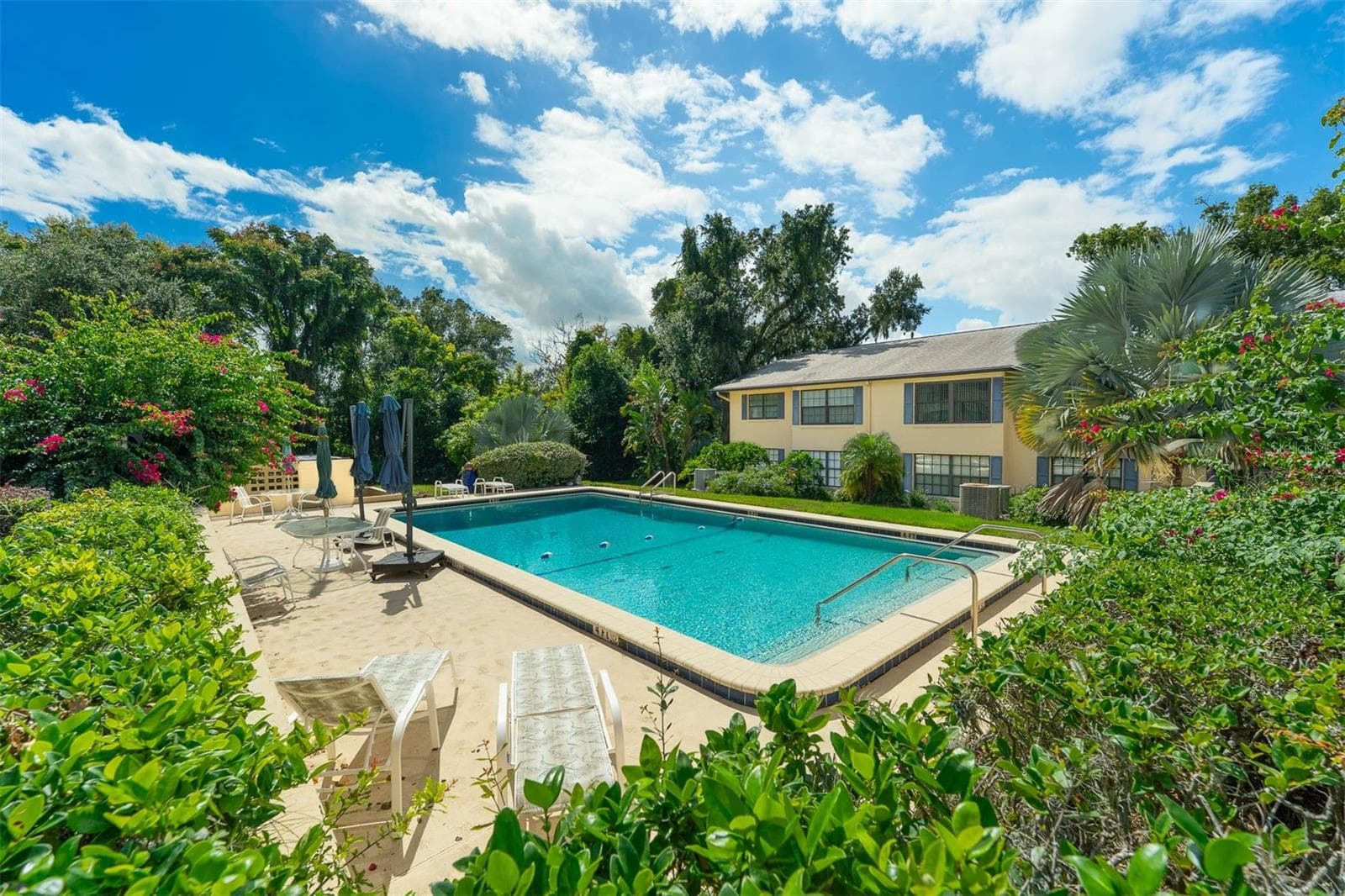 Lush Landscaping throughout the property and lovely pool area - 110 N TREMAIN ST #209, MOUNT DORA