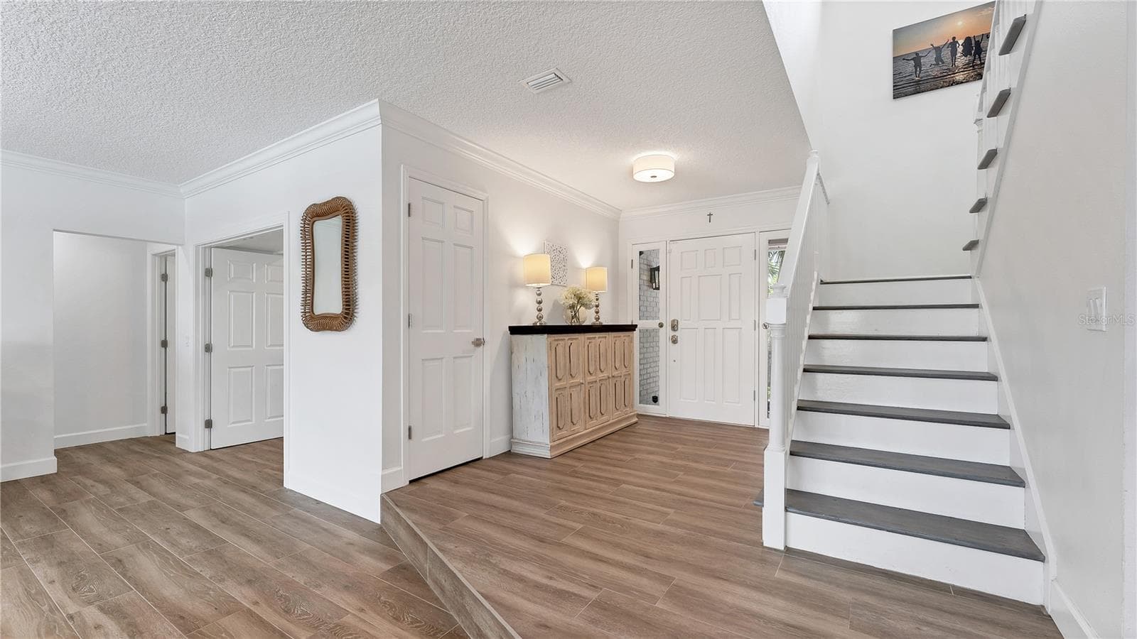 Front entryway with staircase to 2nd level (Previously staged) - 5623 HULL CT, NEW PORT RICHEY