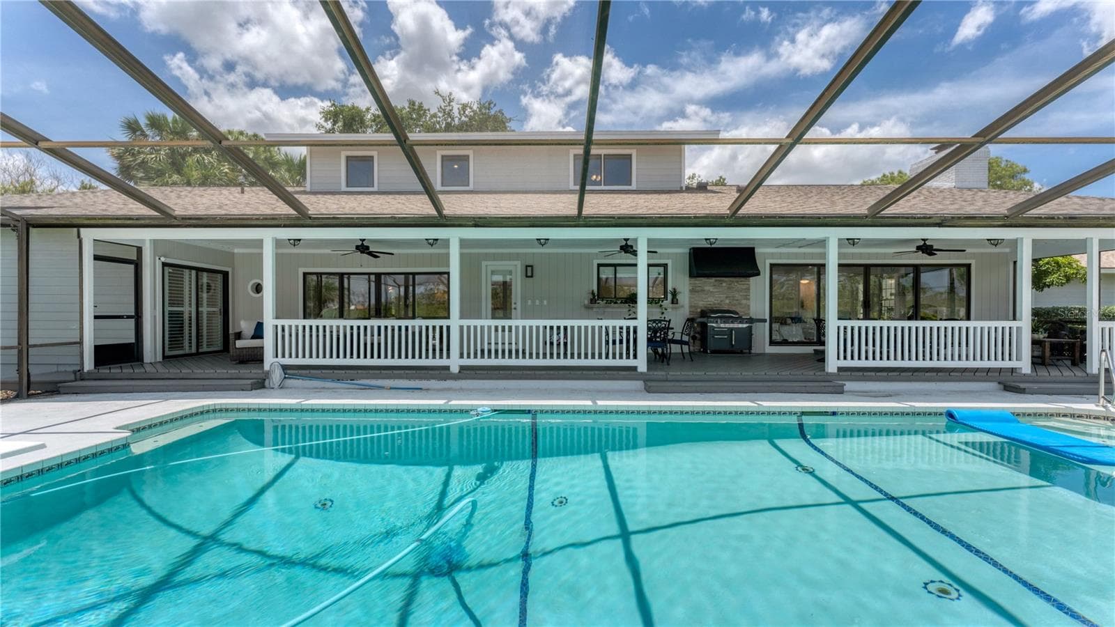 View of pool and covered porch under screen(previously staged) - 5623 HULL CT, NEW PORT RICHEY