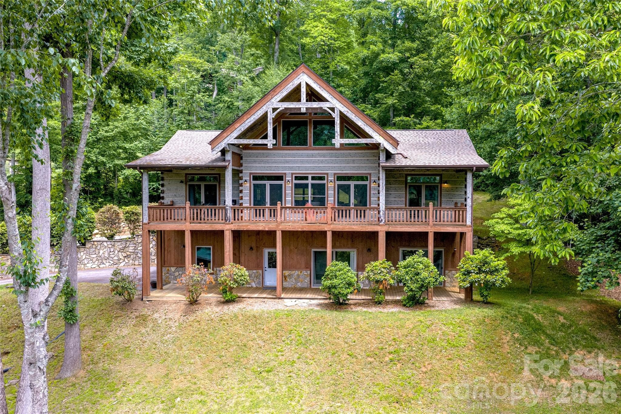 Post and Beam accents... Covered porches extend across the full length on two levels at 170 Cradling Cove, Waynesville NC - Waynesville