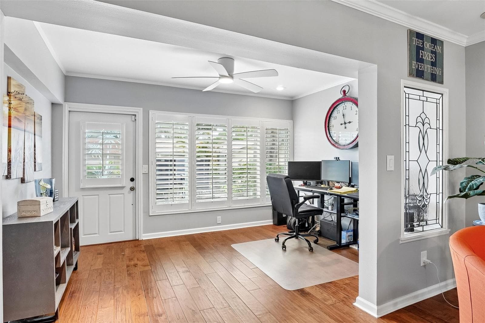 Sunroom / flex space with wall of windows dressed with Key West style plantation shutters is ideal for office, morning coffee, reading or just relaxing. - 3259 HILARY CIR #1C, PALM HARBOR
