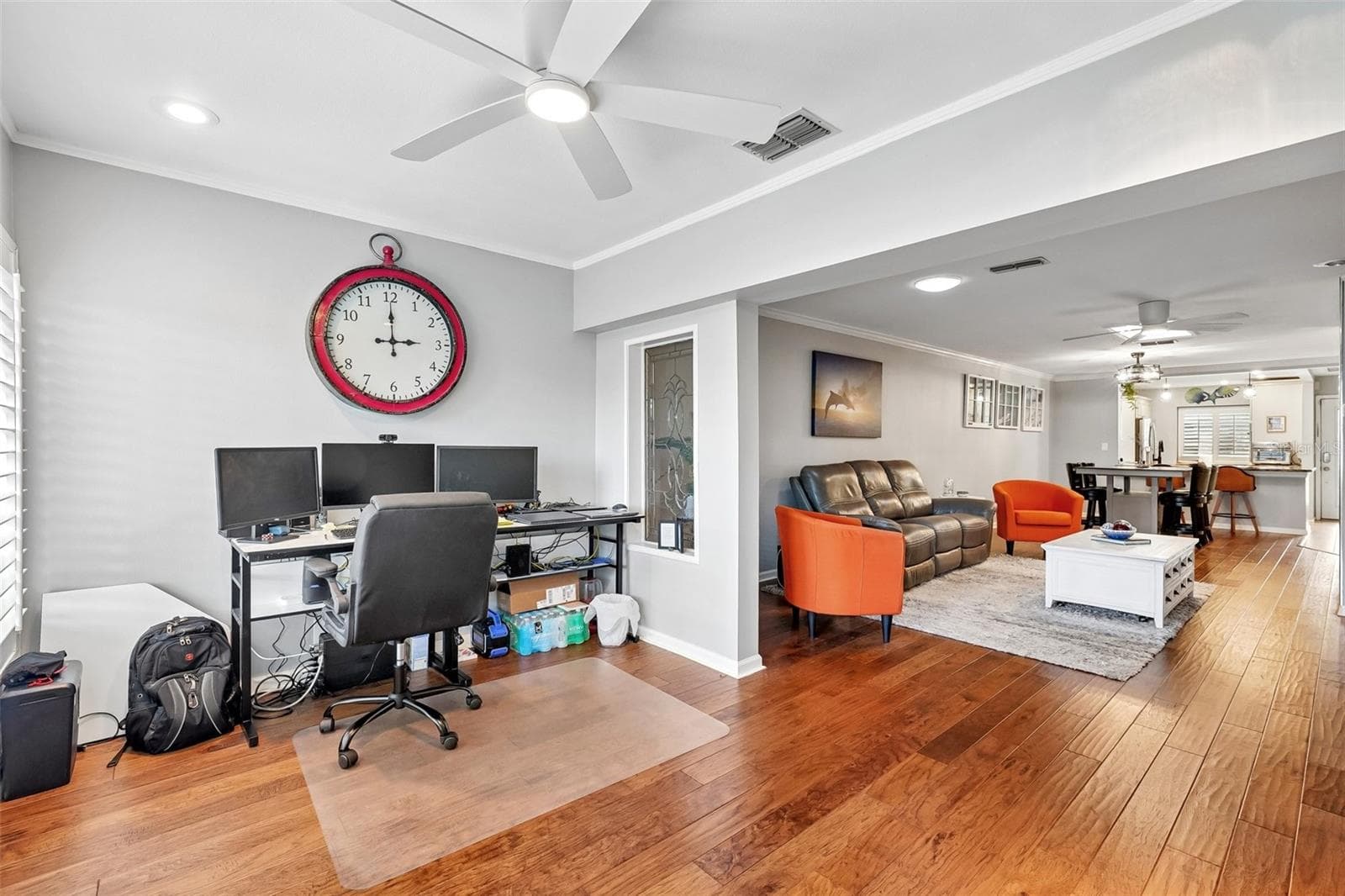 Sunroom / flex space with wall of windows dressed with Key West style plantation shutters is ideal for office, morning coffee, reading or just relaxing. - 3259 HILARY CIR #1C, PALM HARBOR