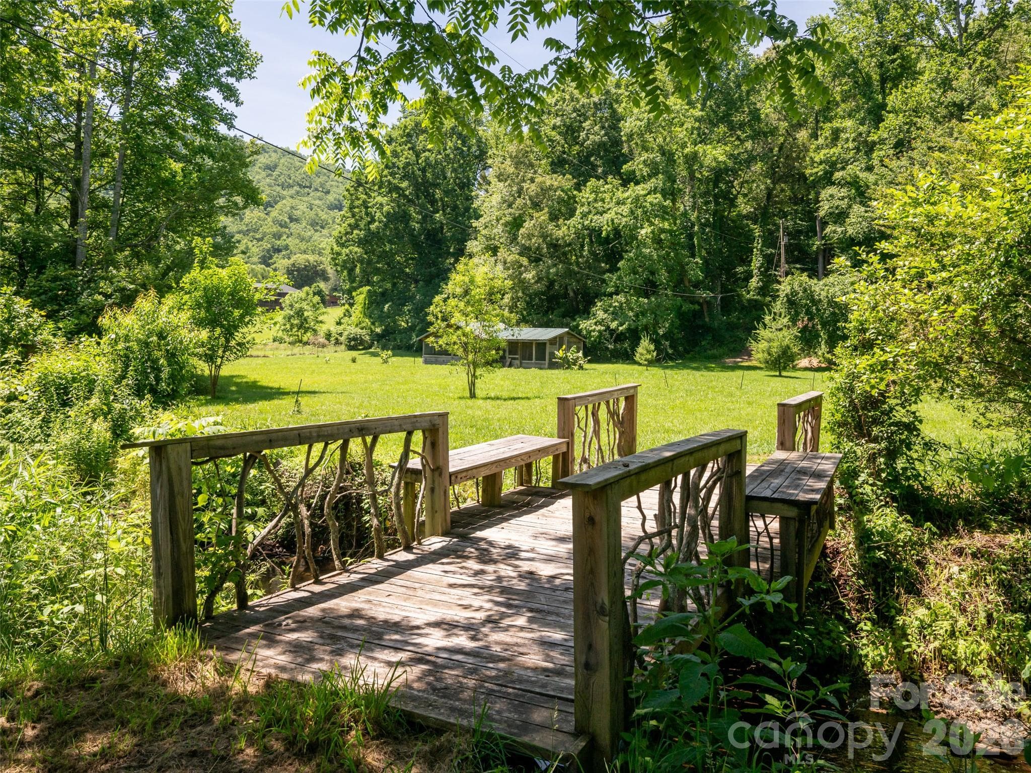 Walking bridge with pasture and smaller barn - 508 Avery Creek Road, Arden