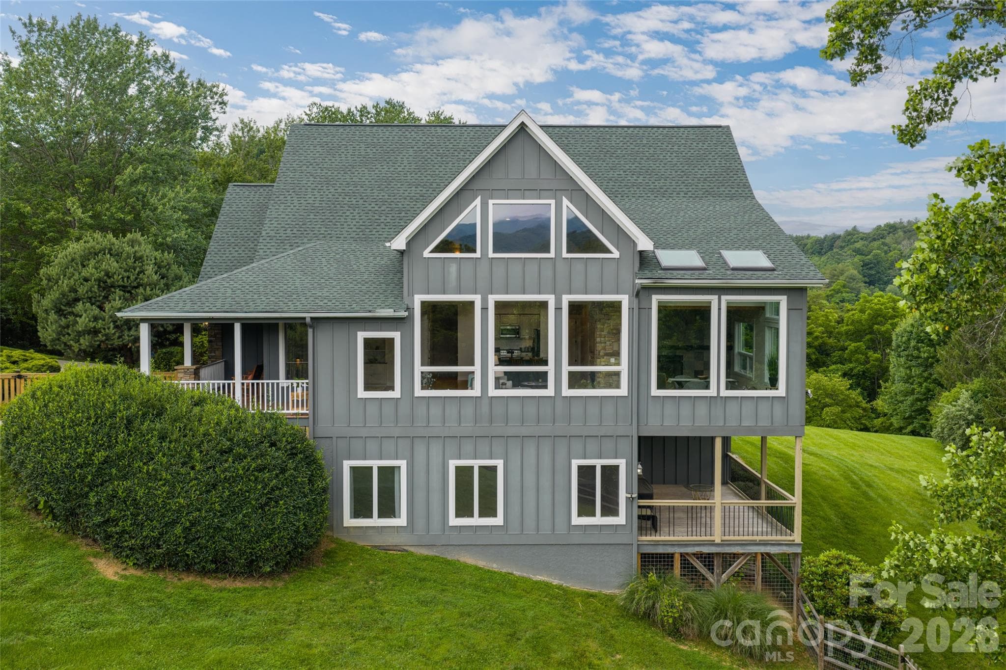 Spacious front covered porch and large lower-level covered back porch, perfect for outdoor living and entertaining. - 33 Bridle Path Drive, Barnardsville