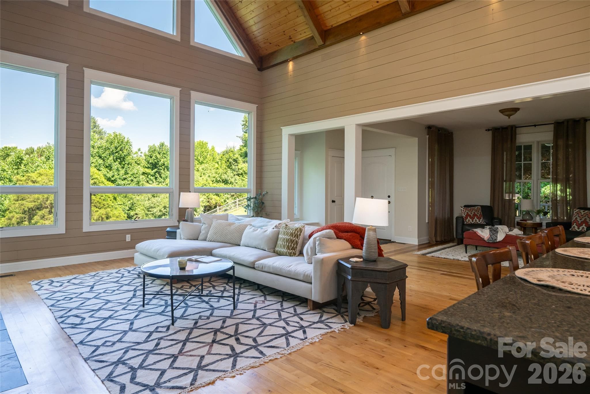 The great room flows seamlessly into a formal sitting area featuring custom built-ins. - 33 Bridle Path Drive, Barnardsville