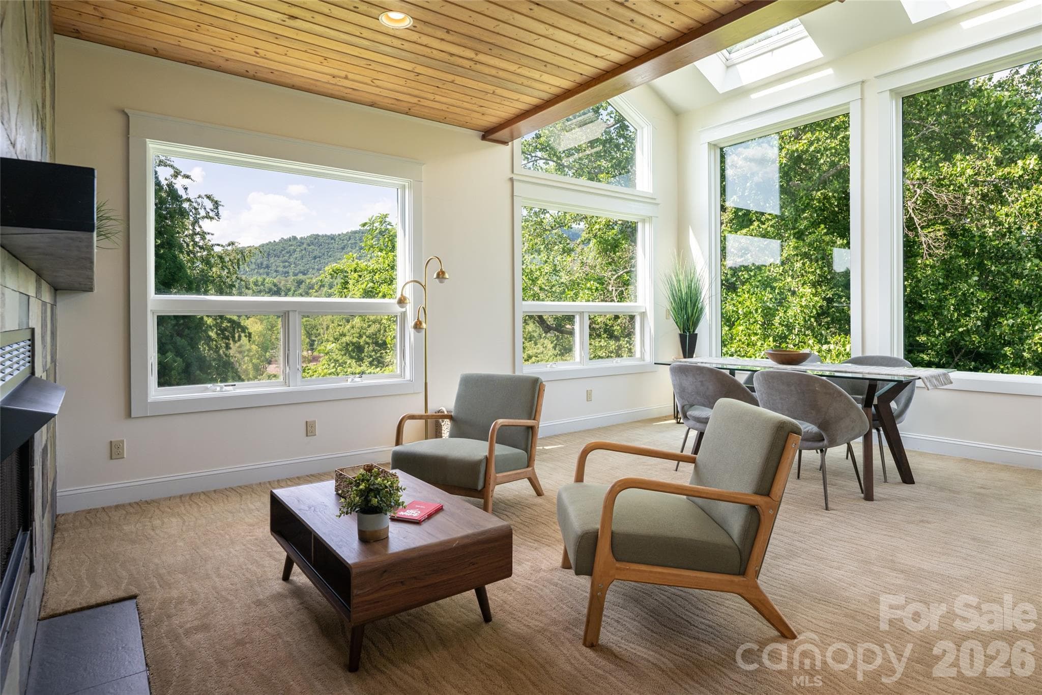 This formal dining room features an additional entertaining area and a second fireplace, creating an atmosphere of true luxury. - 33 Bridle Path Drive, Barnardsville