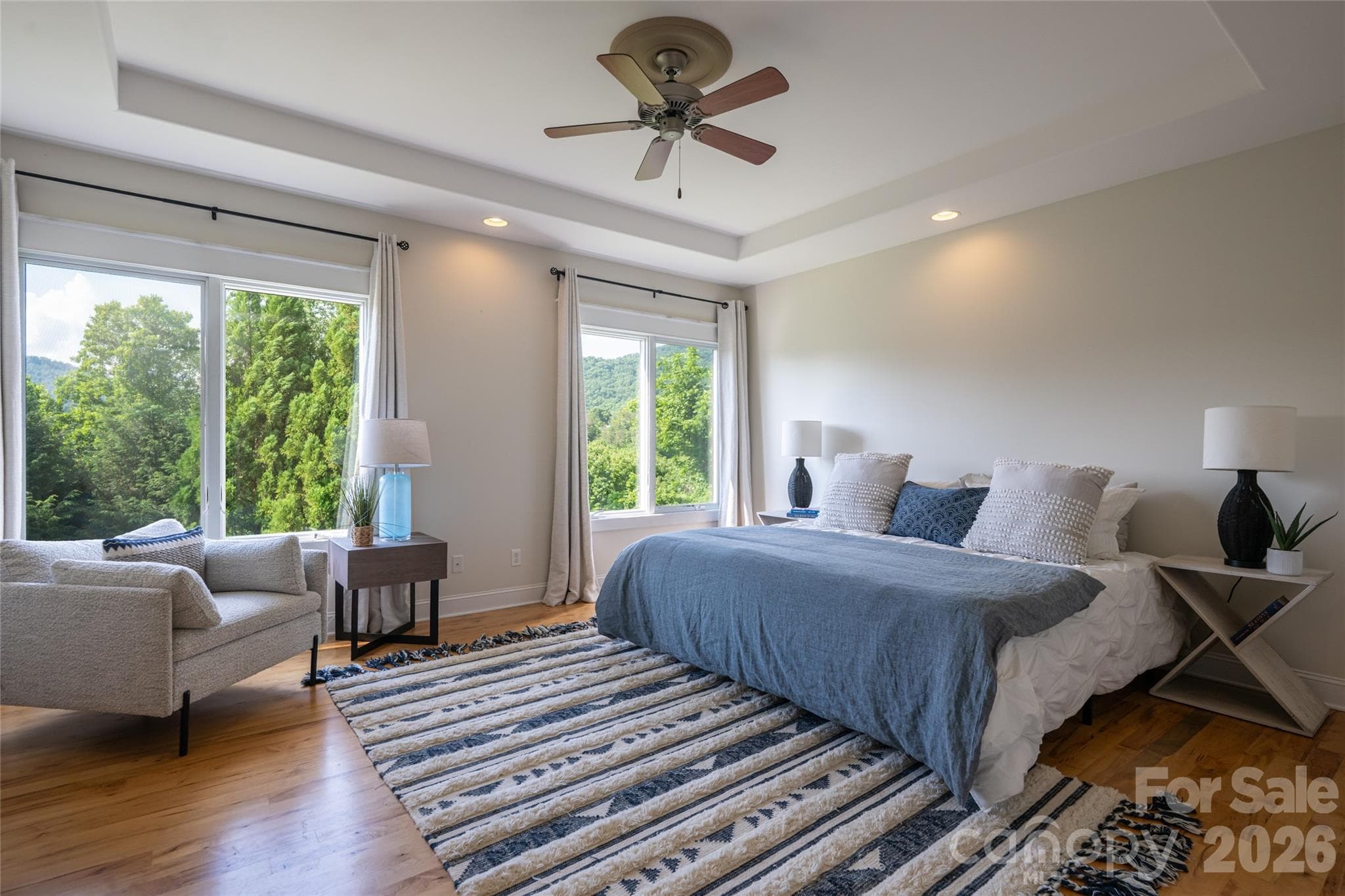 This main-level primary suite offers a peaceful retreat with a tranquil, treehouse-inspired feel. - 33 Bridle Path Drive, Barnardsville