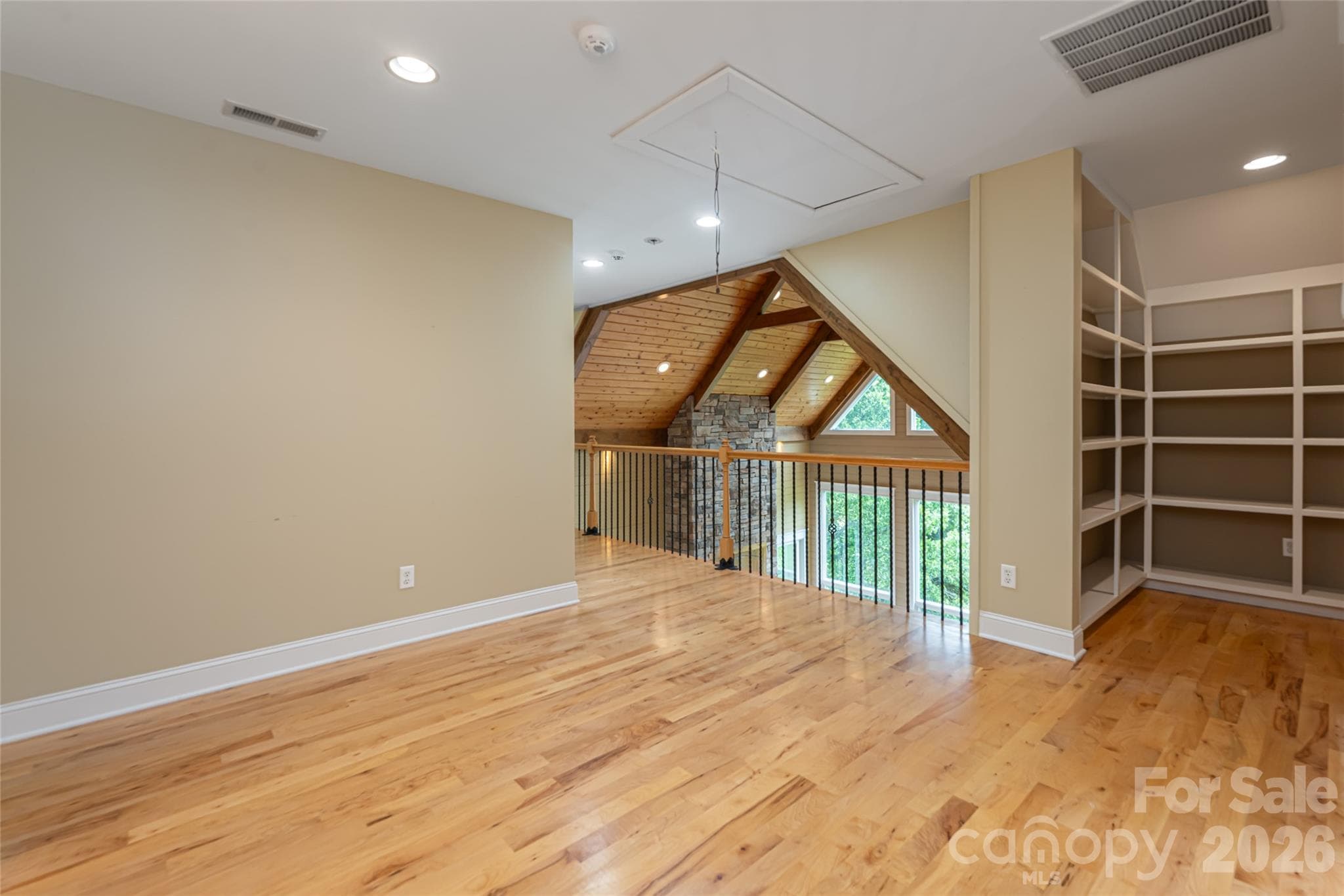 2nd level sitting area with built ins provide valuable storage - 33 Bridle Path Drive, Barnardsville