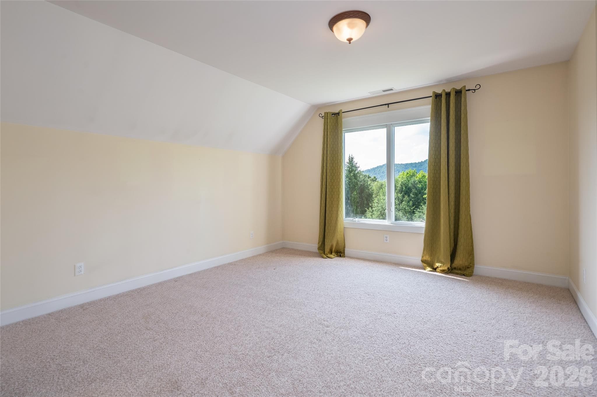 Versatile upper-level guest suite, highlighting its privacy and comfort within the home's layout. - 33 Bridle Path Drive, Barnardsville