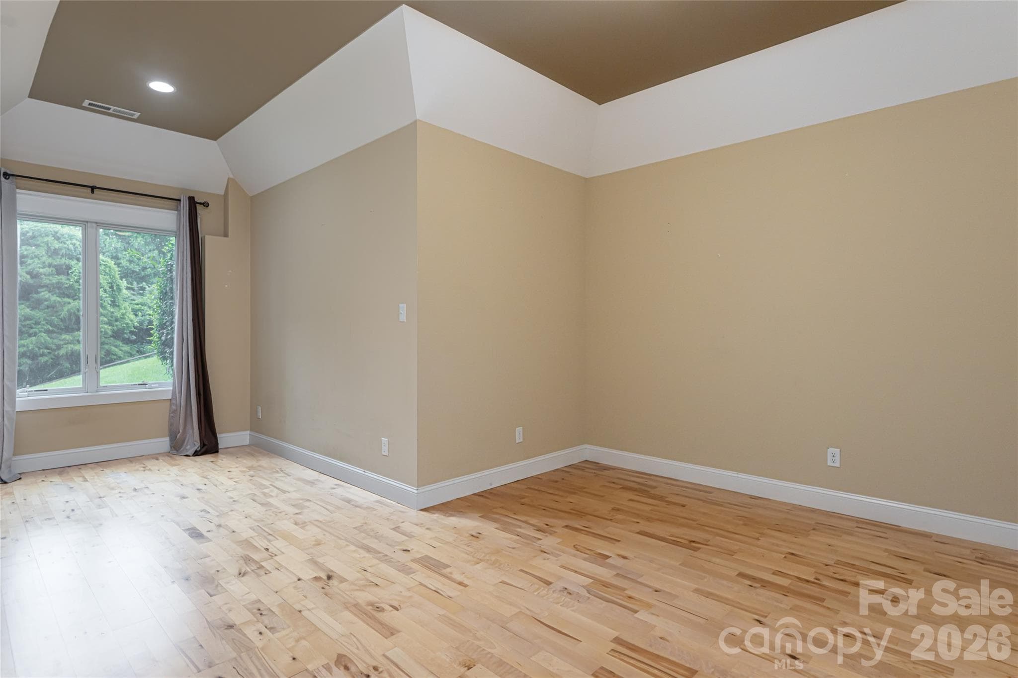 Spacious lower-level guest bedroom with generous proportions. - 33 Bridle Path Drive, Barnardsville
