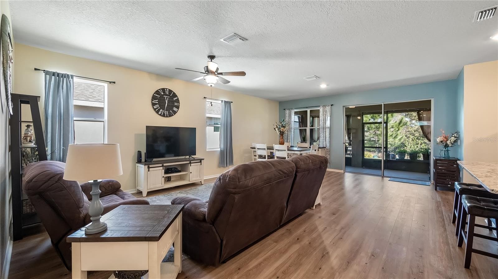 Living room with two windows that provide natural light and new luxury vinyl plank flooring throughout. - 8033 PENROSE PL, WILDWOOD
