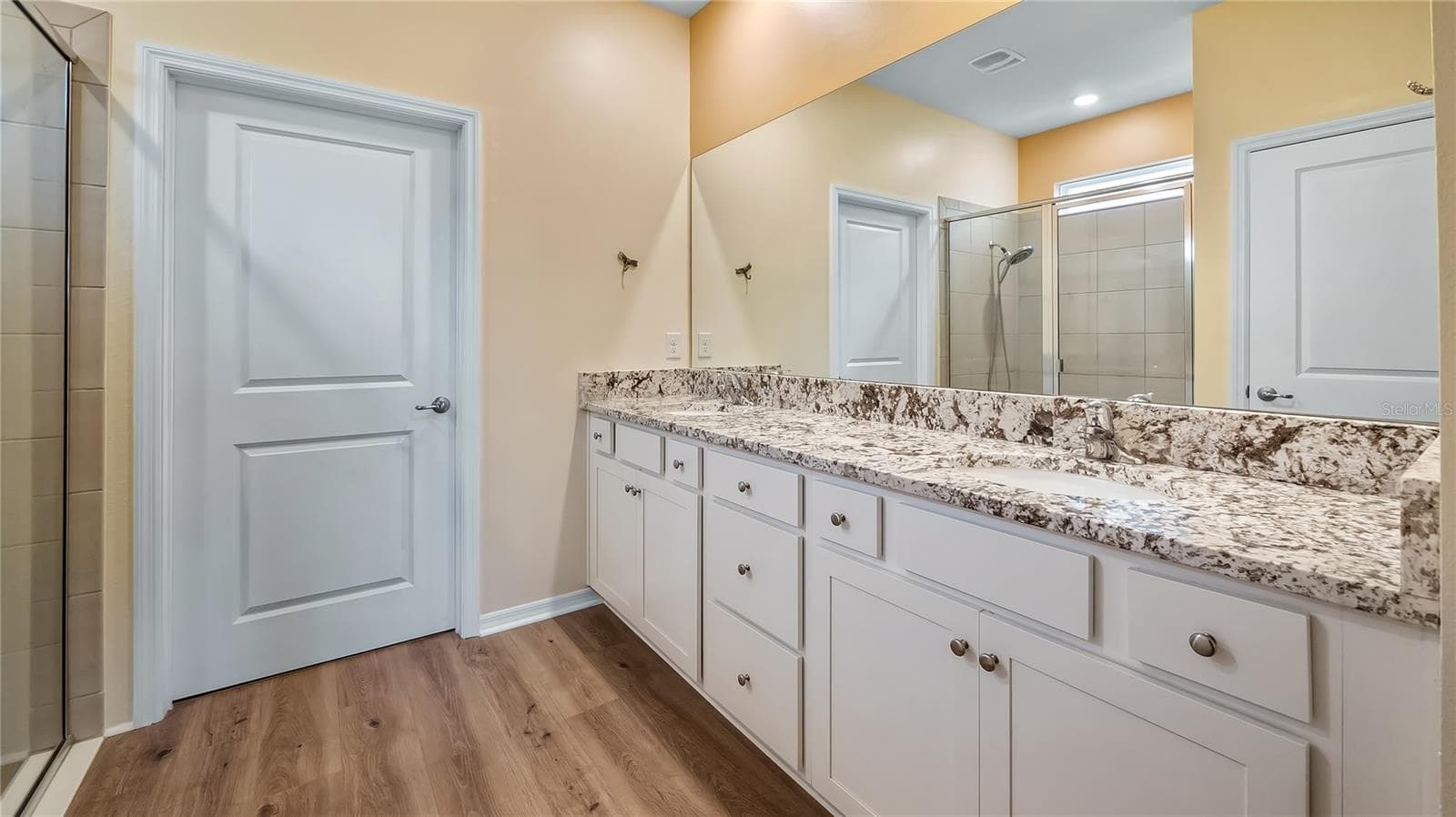 Primary bathroom with dual vanity and walk-in closet and shower. - 8033 PENROSE PL, WILDWOOD