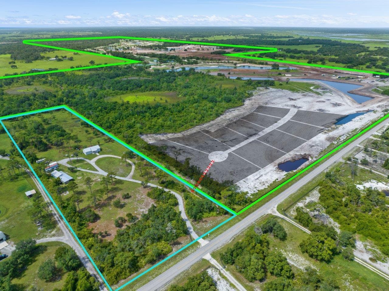 Overview of the property showing the listing highlighted in Bue while Soleta is highlighted in green. The Grey shadows show the estimated lots being constructed in Solete with the red line being the access point into the community from the listing. - 34452 SINGLETARY RD, MYAKKA CITY