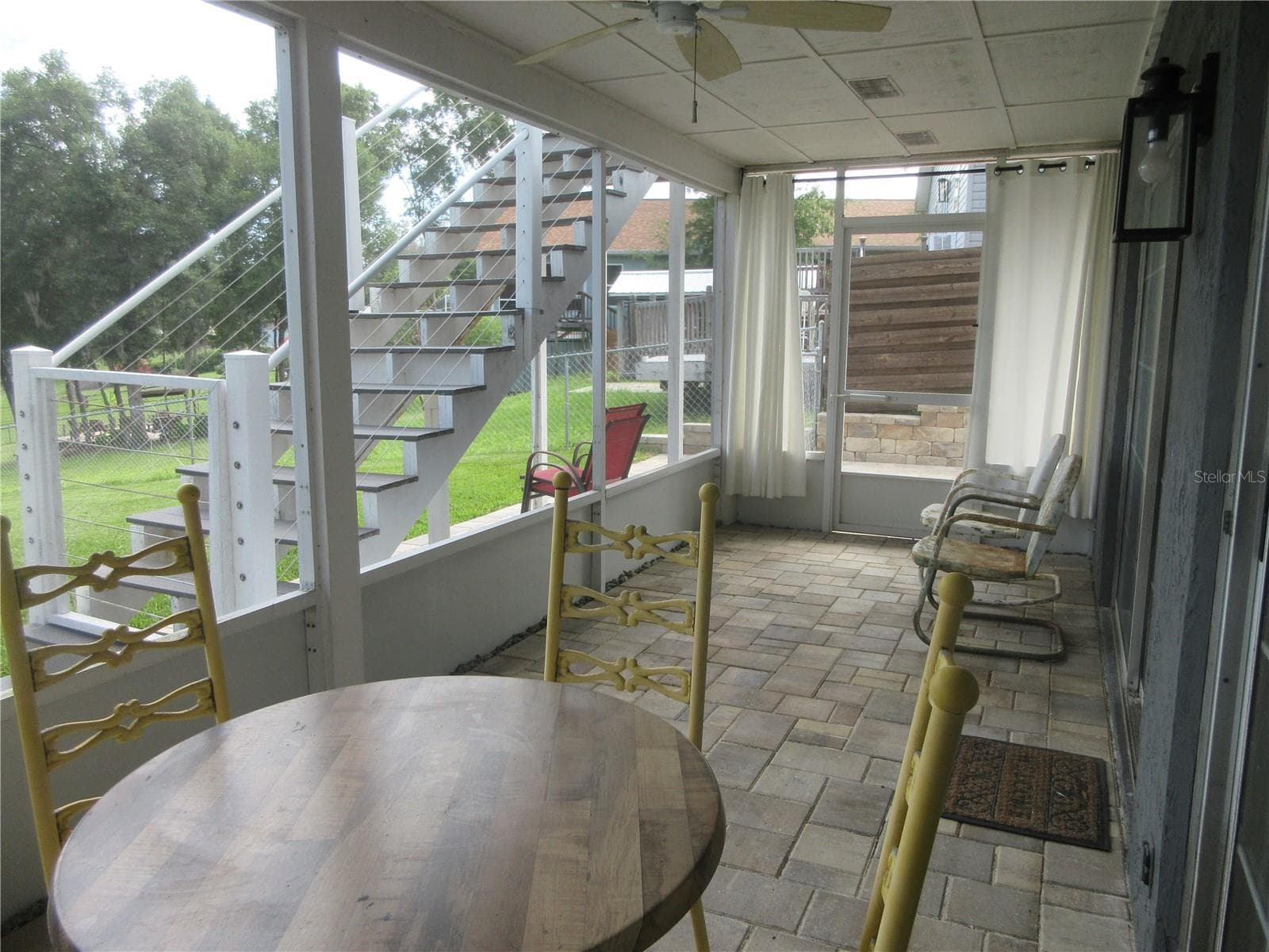 bottom story screened veranda with pavers - 16849 SE 59TH PL, OCKLAWAHA