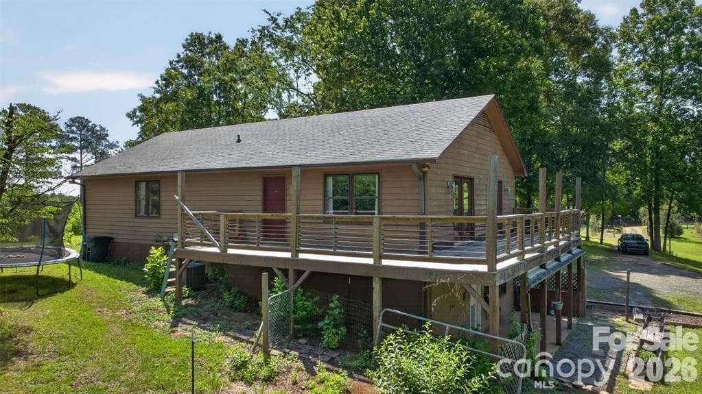 Rear view showing wraparound deck. - Mill Spring