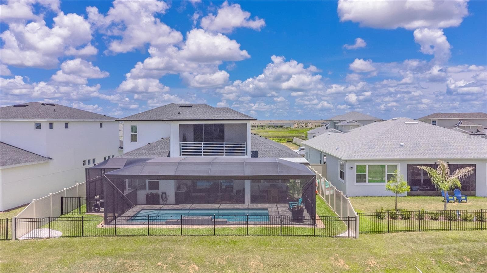 View of the back of the home and pool lanai. - 10706 TORCHWOOD SEA WAY, SAN ANTONIO