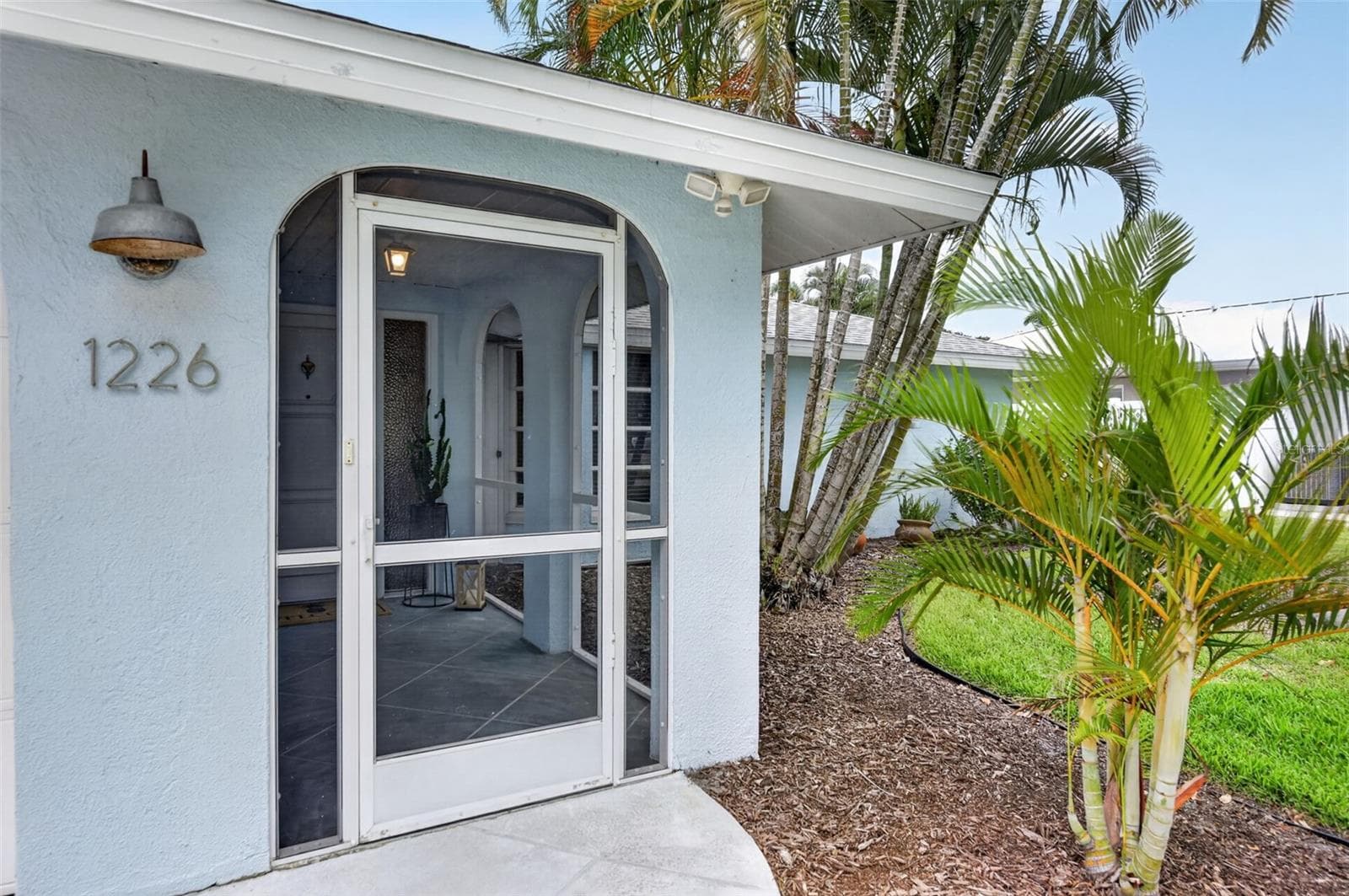 Front door with screened in entry way - 1226 PINE NEEDLE RD, VENICE