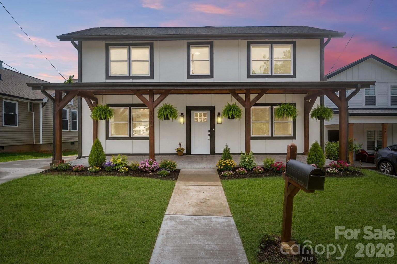 Flowers and ferns virtually staged at twilight - 174 Tournament Drive SW, Concord