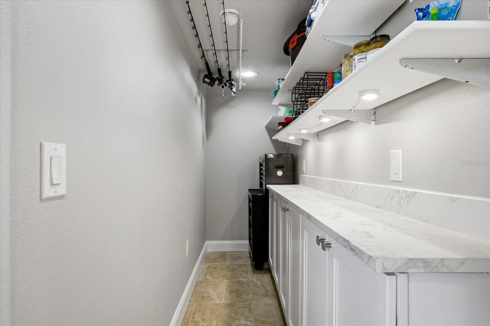 Custom Pantry with Fishing Rod Storage and Room for Tools - 610 ISLAND WAY #201, CLEARWATER BEACH