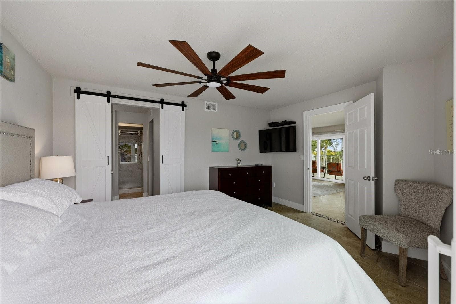 Barn doors leading to primary bathroom and closet - 610 ISLAND WAY #201, CLEARWATER BEACH