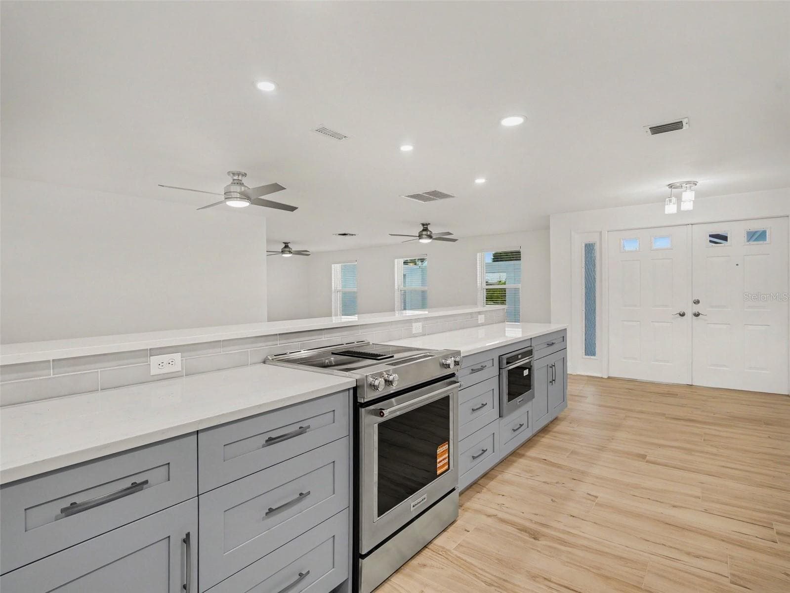 Kitchen overlooking dining/living rooms and front door/foyer - 548 BELVEDERE CT, PUNTA GORDA